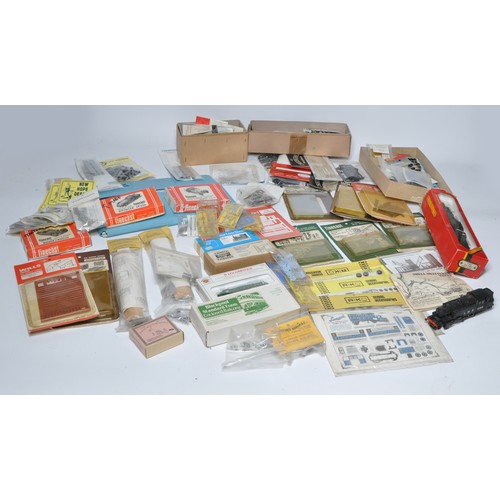 594 - A comprehensive group of model railway items to include plastic and white metal kits relating to tra... 