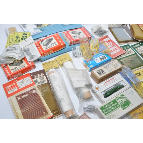 594 - A comprehensive group of model railway items to include plastic and white metal kits relating to tra... 