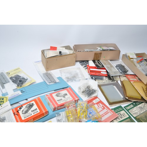 594 - A comprehensive group of model railway items to include plastic and white metal kits relating to tra... 