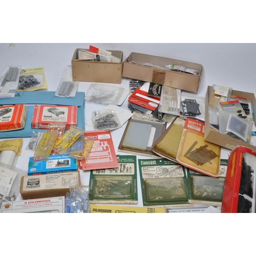 594 - A comprehensive group of model railway items to include plastic and white metal kits relating to tra... 