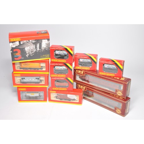 94 - Model railway comprising a group of 12 rolling stock issues, as shown. Hornby etc. Look unused, with... 