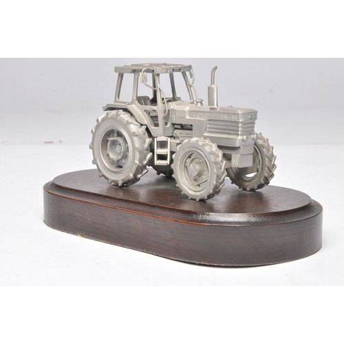 200 - Pewter Ford TW-35 Tractor mounted on a wooden plinth marked Basildon Tractor Production 1984-1989. P... 