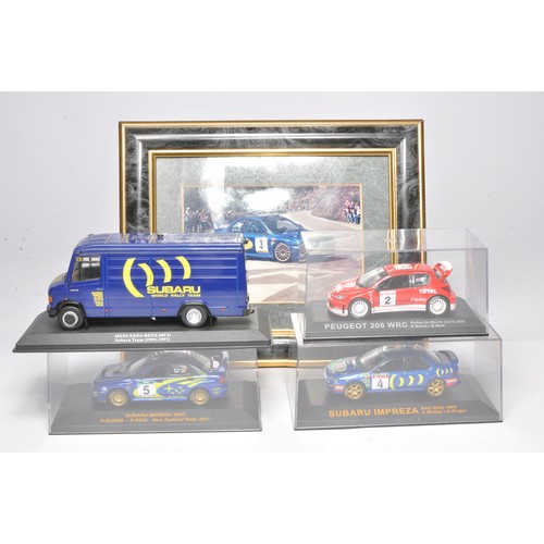 357 - A selection of 1/43 Rally cars in display cases as shown, in addition to Subaru service van.