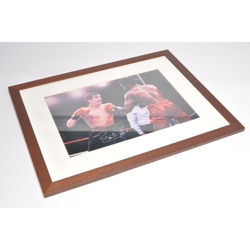 451 - Autographs. A framed and signed photograph of Barry McGuigan. With COA.