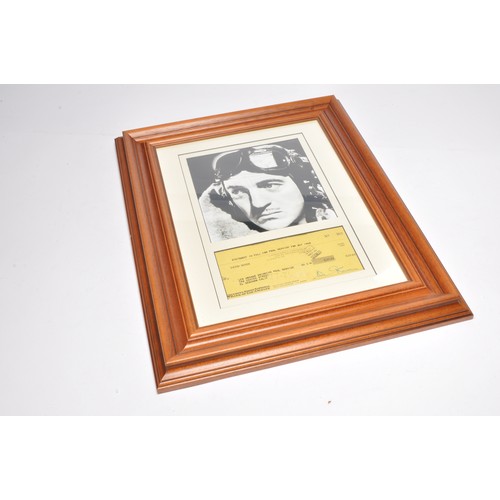 453 - Autographs. A framed and signed photograph and signed cheque from David Niven. With COA.