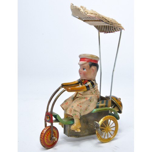 479 - A vintage Japanese or Chinese mechanical tricycle with rider, as shown. With notable wear but in wor... 