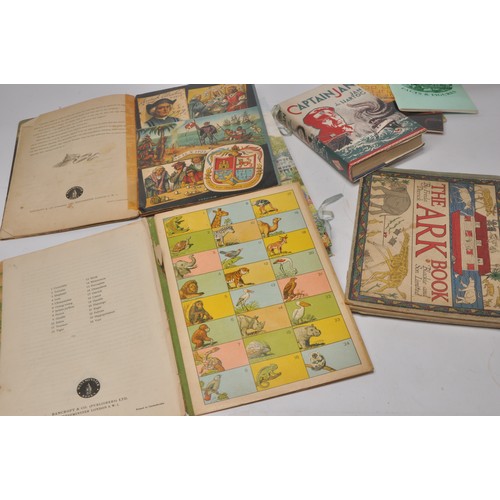 33 - An assortment of vintage book and children's publications including attractive pop-up books, annuals... 