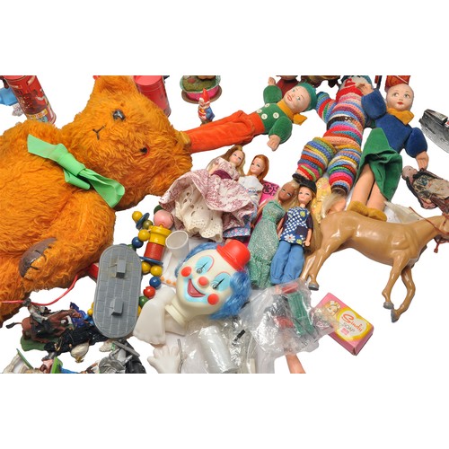 86 - A misc assortment of vintage children's toys and related bygones to include fashion dolls, mechanica... 