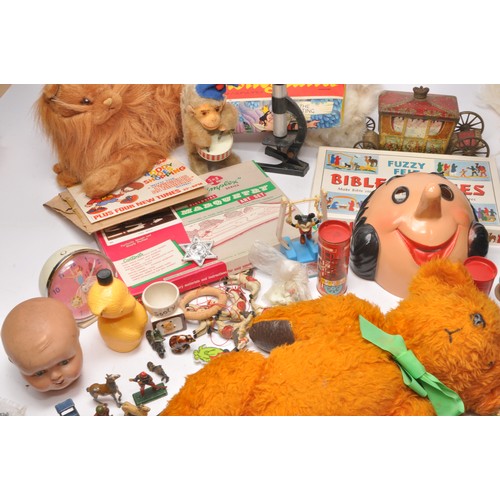 86 - A misc assortment of vintage children's toys and related bygones to include fashion dolls, mechanica... 