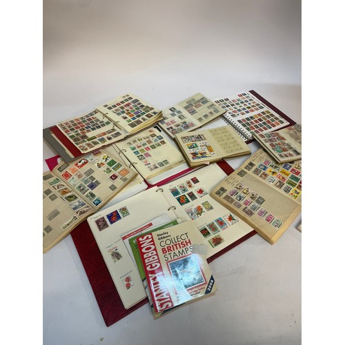 602 - A varied collection of stamps comprising several albums containing used and unused examples from aro... 