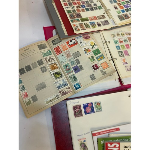 602 - A varied collection of stamps comprising several albums containing used and unused examples from aro... 