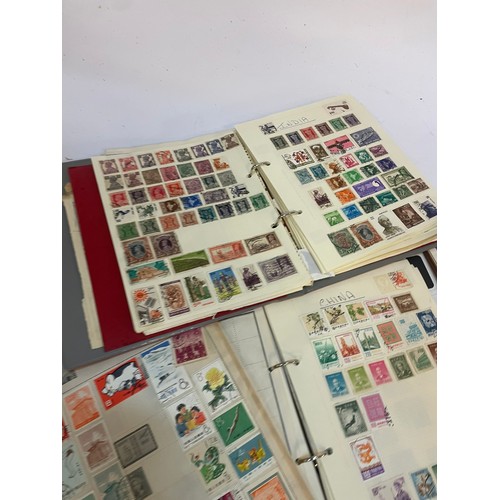 602 - A varied collection of stamps comprising several albums containing used and unused examples from aro... 