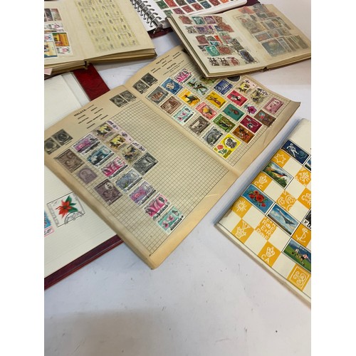 602 - A varied collection of stamps comprising several albums containing used and unused examples from aro... 