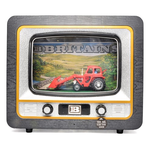 A Britains Farm Working Shop Display comprising 'working' Massey Ferguson 135 Tractor with Front Loader. The mock TV operates the model's loader up and down, in addition to a working light within the TV. This is a modern reproduction of the original from the 1970's.