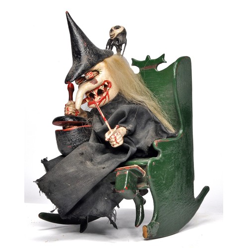 Extremely Rare and 'Terrifying' W. Summerbell crafted and intricate Clockwork Automata figure comprising of a Witch sitting in her rocking chair stirring her cauldron containing a skull and a blooded hand sword in her left hand. Her head and hands move with the clockwork mechanism and although the mechanism is working it  does require some attention, plus front part of left chair runner is missing. A very similar toy is pictured on page 1 of Mechanical Toys by Athelstan and Kathleen Spilhaus, circa 1920's. Also included is a handmade witch on a broom stick.  Dimension: 30cm x 14 cm x 13.5