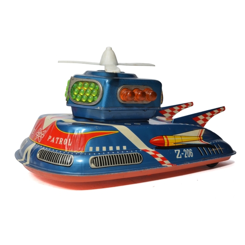 A TPS (Japan) tinplate battery-operated space patrol vehicle, printed as Z-206, with plastic turret, propeller, and light lenses. Excellent with little sign of wear. Unboxed.