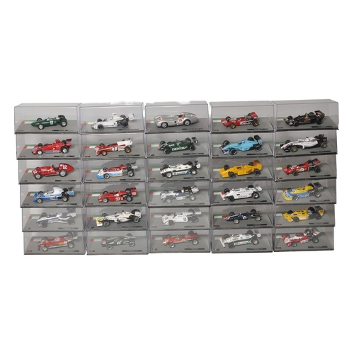 A large collection of diecast Formula 1 racing car models, each housed ...