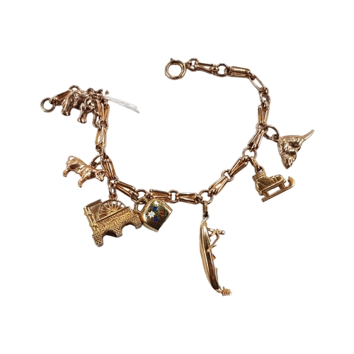 575 - 9 CARAT GOLD CHARM BRACELET CONSISTING OF 9/14/18 CARAT GOLD CHARMS 20.8 GRAMS