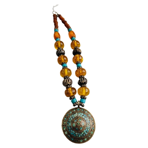 419 - UNUSUAL TURQUOISE WHITE METAL PENDANT ON AMBER BEADED NECKLACE