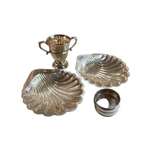 292 - 2 SILVER SHELL DISHES, 2 NAPKIN RINGS & SILVER TROPHY - 177 GRAMS TOTAL