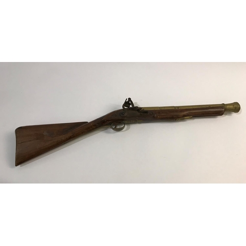 432 - A FLINTLOCK BLUNDERBUSS. A flintlock blunderbuss with associated brass barrel and stock, possibly of... 