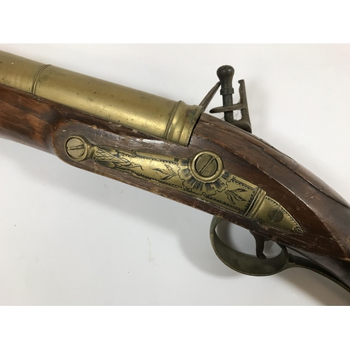 432 - A FLINTLOCK BLUNDERBUSS. A flintlock blunderbuss with associated brass barrel and stock, possibly of... 