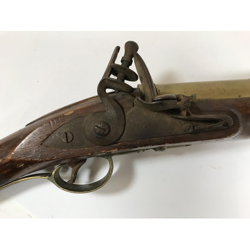 432 - A FLINTLOCK BLUNDERBUSS. A flintlock blunderbuss with associated brass barrel and stock, possibly of... 