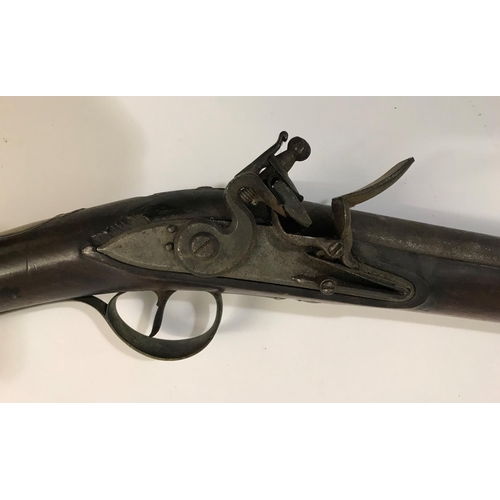 433 - A FLINTLOCK BLUNDERBUSS. A flintlock blunderbuss with flared brass barrel, top mounted sprung bayone... 