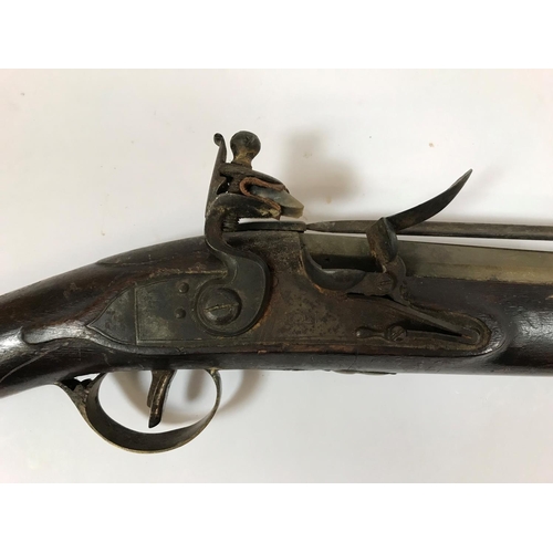 475 - A BRASS BARREL BLUNDERBUSS STAMPED H. NOCK. A brass barrel flintlock blunderbuss by H. Nock, with fl... 