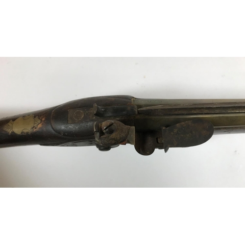 475 - A BRASS BARREL BLUNDERBUSS STAMPED H. NOCK. A brass barrel flintlock blunderbuss by H. Nock, with fl... 