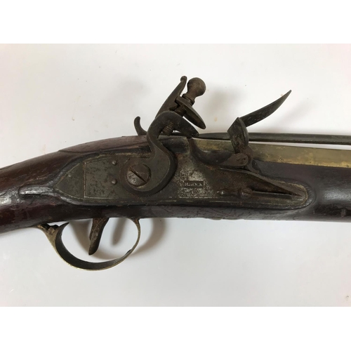 476 - A BRASS BARREL BLUNDERBUSS MARKED H. NOCK. A brass barrell flintlock blunderbuss by H. Nock, with fl... 