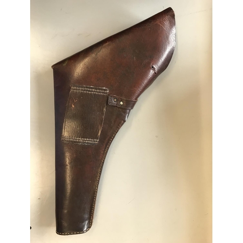 496 - A LEATHER PISTOL HOLSTER. A large leather pistol holster with buckle and strap fastening, probably S... 