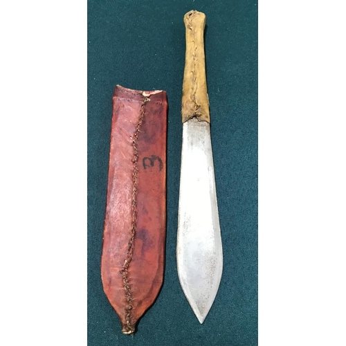 516 - AN AFRICAN TRIBAL KNIFE. An African hunting knife with broad flat double edged 17cm blade with a ski... 