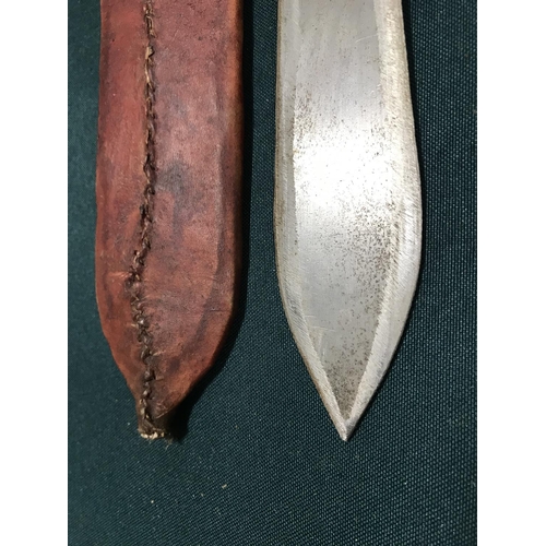 516 - AN AFRICAN TRIBAL KNIFE. An African hunting knife with broad flat double edged 17cm blade with a ski... 