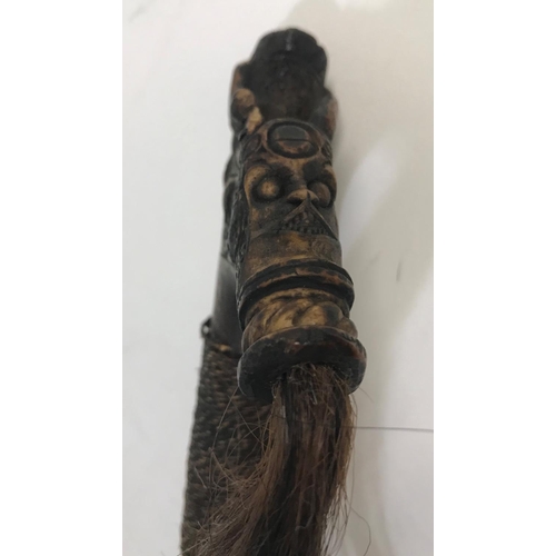 531 - BORNEO HEAD HUNTERS SWORD AND SCABBARD. An unusual Head Hunters Sword (mandau) with elaborate carved... 