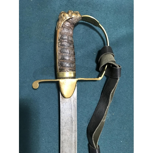 555 - A 19TH CENTURY HANGER. A 19th century brass stirrup hilted hanger with curved 72cm single edged blad... 