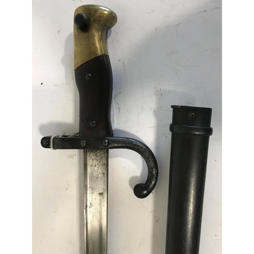 589 - A 19TH CENTURY FRENCH SWORD BAYONET AND SCABBARD. A French Sword Bayonet with a 52cm straight blade,... 