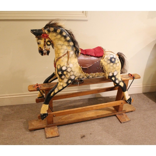 1392 - ANTIQUE ROCKING HORSE a painted wooden rocking horse, mounted on a wooden trestle base. 118cms high,... 