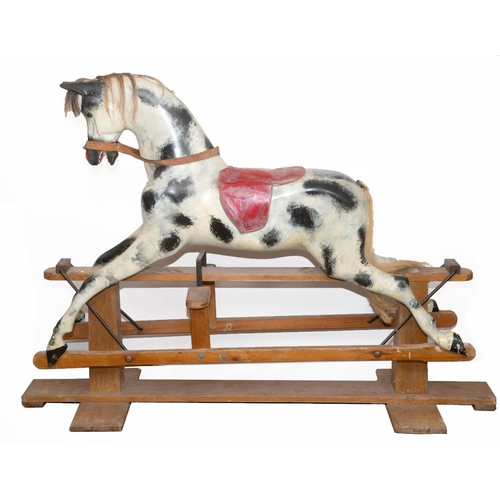 1402 - HADDON ROCKING HORSE a large fibreglass rocking horse, fitted with a saddle and bridle and mounted o... 