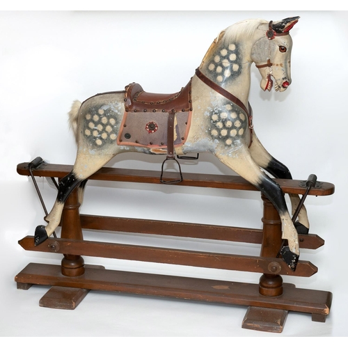 1413 - ANTIQUE ROCKING HORSE a painted wooden rocking horse, fitted with a leather saddle and stirrups and ... 