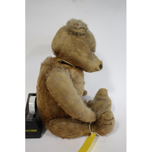 1484 - VINTAGE TEDDY BEAR a large vintage Bear with the remains of a cinnamon coloured mohair body, with a ... 