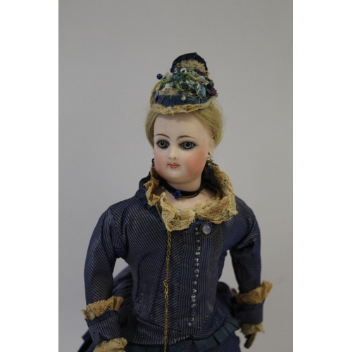 1507 - 19THC FRENCH FASHION DOLL a long faced French bisque head doll with swivel neck, with pale blue ring... 