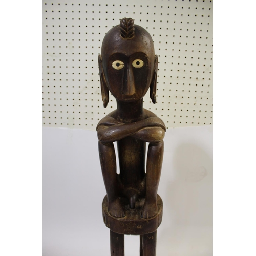 1541 - LARGE TRIBAL FIGURE - TIMOR a large carved figure with elongated ears and inset bone eyes, in a seat... 