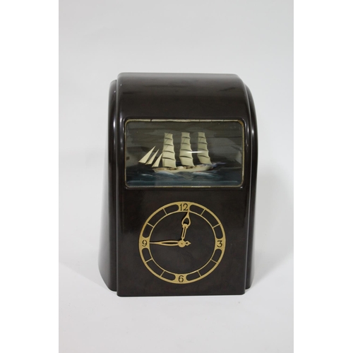 1563 - VITASCOPE BAKELITE SHIP CLOCK a Vitascope brown bakelite mantle clock, with an automated Ship (in wo... 