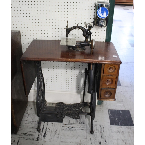 1586 - WILLCOX & GIBBS TREADLE SEWING MACHINE a small cast iron sewing machine mounted on a folding wooden ... 