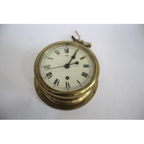 1645 - SHIPS CLOCK a ships clock with a brass case and a white enamel dial, with 2 keys and in working orde... 