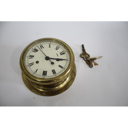 1645 - SHIPS CLOCK a ships clock with a brass case and a white enamel dial, with 2 keys and in working orde... 