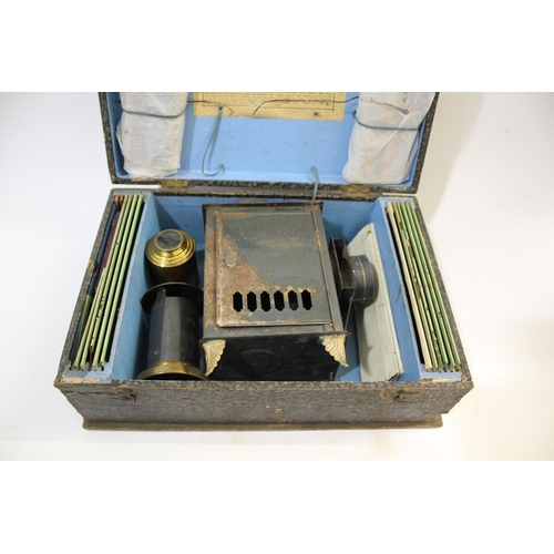 1699 - CASED GERMAN MAGIC LANTERN & SLIDES - FABRIK MARKE a boxed magic lantern with brass lens, with a var... 