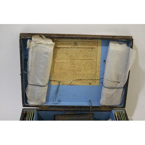 1699 - CASED GERMAN MAGIC LANTERN & SLIDES - FABRIK MARKE a boxed magic lantern with brass lens, with a var... 