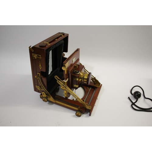 1702 - SANDERSON PLATE CAMERA a mahogany plate camera with a Beck Symmetrical Lens (leather cap with paper ... 